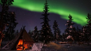 Northern Lights above tents at the reindeer lodge in Jukkasjärvi, Sweden